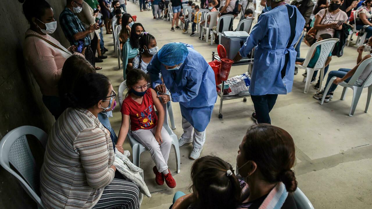 People are inoculated at a vaccination center at a Volleyball arena where vaccines against COVID-19 are being used to inoculate people, amid the novel coronavirus pandemic, in Medellin on December 1, 2021. Health authorities in Colombia, have imposed a prove of a full vaccination scheme to citizens who plan to have access to public places like restaurants and bars.