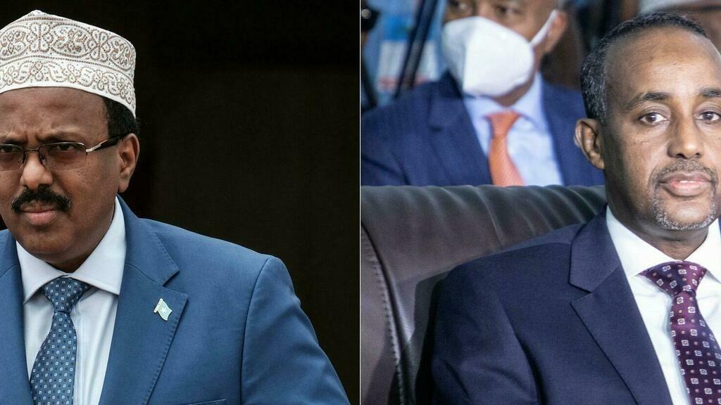(COMBO/FILES) This combination of file pictures created on September 07, 2021 shows Somalia’s President Mohamed Abdullahi Mohamed (L), commonly know as Farmajo walks to make his speech during the inauguration ceremony of Djibouti International Free Trade Zone (DIFTZ) in Djibouti on July 5, 2018 and Somalias Prime Minister Mohamed Hussein Roble (R) attending the closing ceremony after reaching an agreement for the new elections at the National Consultative Council on Elections in Mogadishu, Somalia, on May 27, 2021. – Somalia’s President Mohamed Abdullahi Mohamed announced on December 27, 2021 that he was suspending Prime Minister Mohamed Hussein Roble, a day after the two men sparred over long-delayed elections in the troubled Horn of Africa nation. (Photo by Yasuyoshi CHIBA and Abdirahman Yusuf / AFP)
