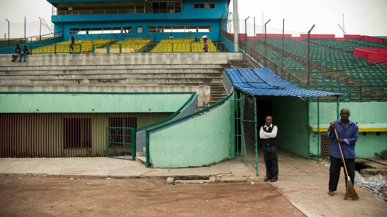 The ground keeper Theophile Kisoto (R) walks inside the Tata Raphael stadium on June 4, 2016, in Kinshasa, where on October 30, 1974 Muhammad Ali defeated George Foreman. – Heavyweight boxing legend Muhammad Ali, a 20th Century icon whose fame transcended sport during a remarkable career that spanned three decades, died Friday, his family said. The 74-year-old sports hero, who had been battling Parkinson’s disease for decades, passed away in a hospital here where he had been admitted earlier this week suffering from respiratory problems. (Photo by JUNIOR KANNAH / AFP)