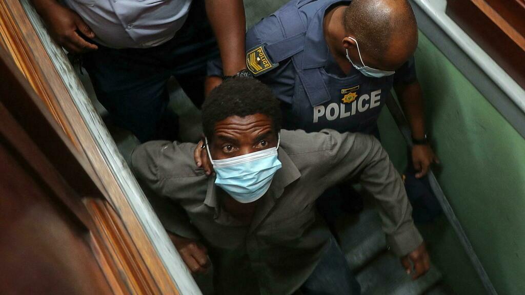 Zandile Christmas Mafe, a suspect accused of breaking into Parliament when the fire started, leaves after appearing in the Cape Town Magistrate Court, in Cape Town, South Africa, January 4, 2022. REUTERS/Sumaya Hisham