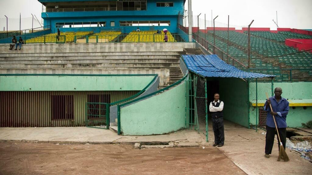 The ground keeper Theophile Kisoto (R) walks inside the Tata Raphael stadium on June 4, 2016, in Kinshasa, where on October 30, 1974 Muhammad Ali defeated George Foreman. – Heavyweight boxing legend Muhammad Ali, a 20th Century icon whose fame transcended sport during a remarkable career that spanned three decades, died Friday, his family said. The 74-year-old sports hero, who had been battling Parkinson’s disease for decades, passed away in a hospital here where he had been admitted earlier this week suffering from respiratory problems. (Photo by JUNIOR KANNAH / AFP)