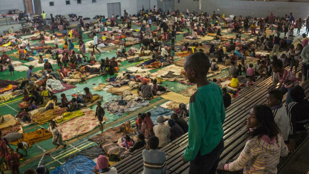 Refugees from the Ankorondrano and Tsaramasay neighbourhoods are currently staying at the Ankorondrano Gymnasium in Antananarivo on January 20, 2022. – Following the heavy rains of the last few days and the rise in water levels in the capital, many neighbourhoods have been completely flooded and the water has risen up to 1 metre in some houses, according to the inhabitants. The Gymnasium of Ankorondrano is currently hosting about 1000 people and the authorities have counted about 8400 refugees hosted in the 18 shelter sites of Antananarivo. (Photo by RIJASOLO / AFP)
