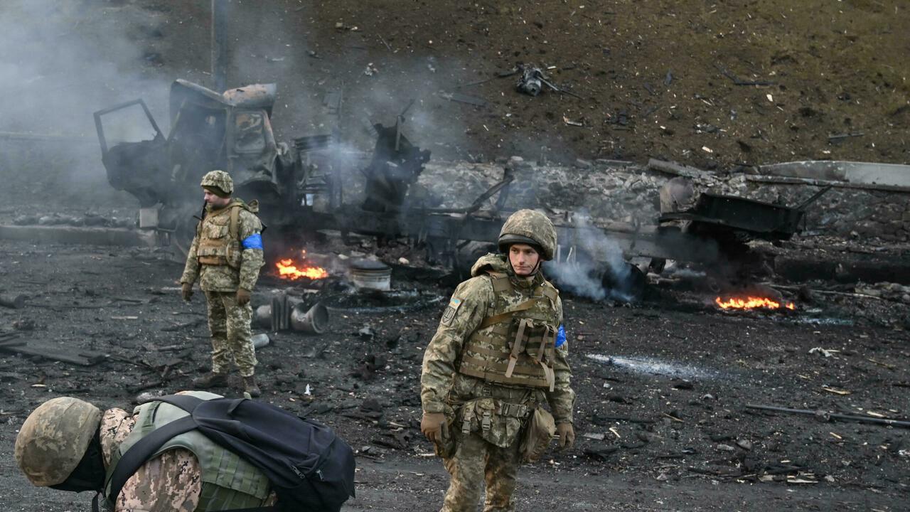 Ukrainian service members look for and collect unexploded shells after a fighting with Russian raiding group in the Ukrainian capital of Kyiv in the morning of February 26, 2022, according to Ukrainian service personnel at the scene. – Ukrainian soldiers repulsed a Russian attack in the capital, the military said on February 26 after a defiant President Volodymyr Zelensky vowed his pro-Western country would not be bowed by Moscow. It started the third day since Russian leader Vladimir Putin unleashed a full-scale invasion that has killed dozens of people, forced more than 50,000 to flee Ukraine in just 48 hours and sparked fears of a wider conflict in Europe. (Photo by Sergei SUPINSKY / AFP)