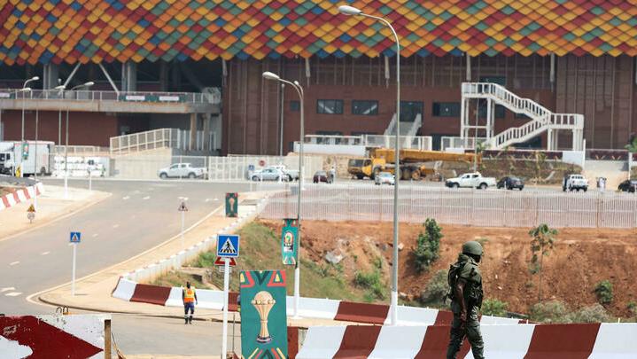 A Cameroonian soldier patrols at the entrance of the Olembe stadium in Yaounde, Cameroon on January 7, 2022, two days before the start of The African Cup of Nations (CAN). (Photo by KENZO TRIBOUILLARD / AFP)