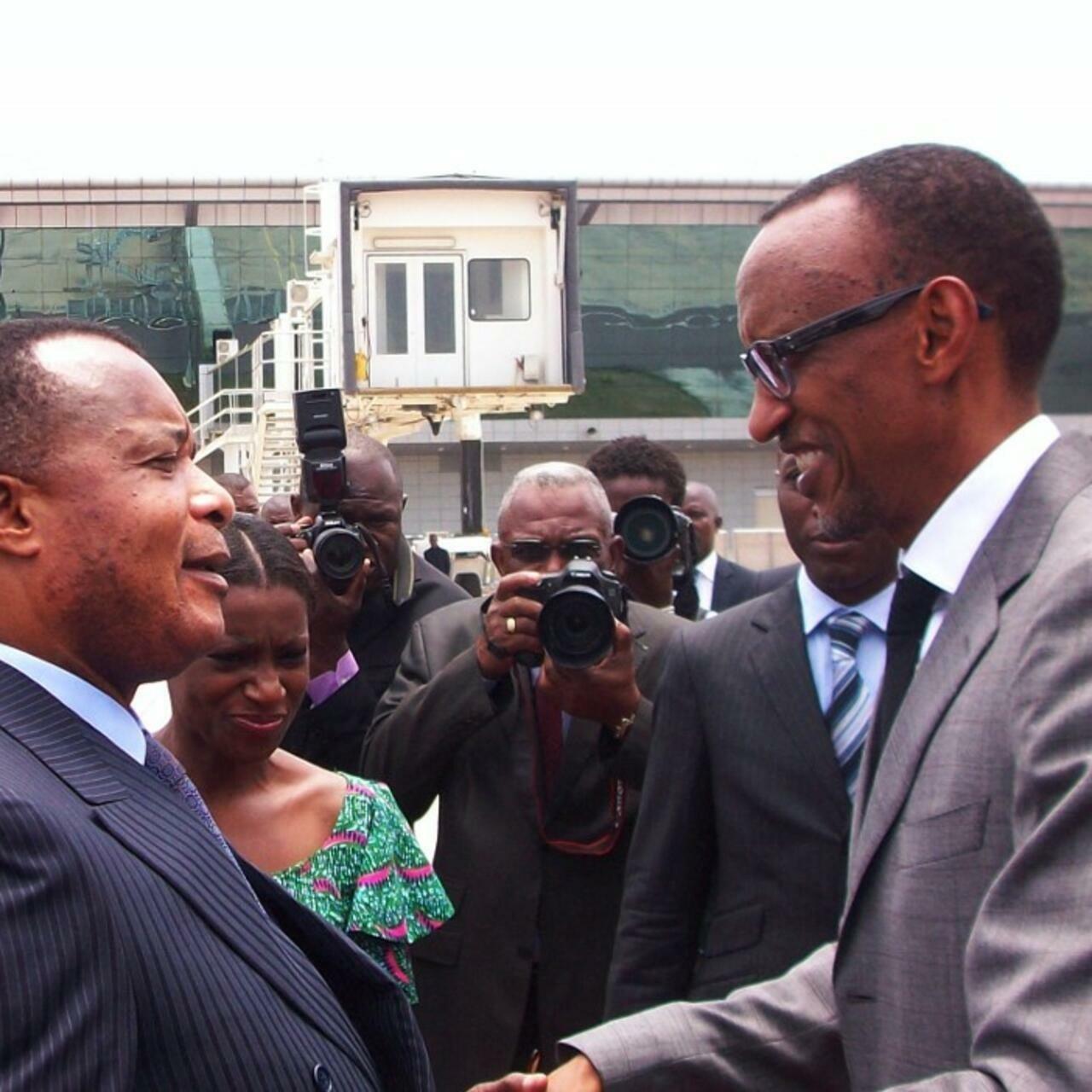 Congo’s President Denis Sassou Nguesso (L) greets his Rwandan counterpart Paul Kagame (R) upon his arrival at Ollombo airport near Oyo, 400km from Brazzaville, on February 16, 2013. Kagame is on an official two-day visit to Congo. AFP PHOTO / Laudes Martial MBON (Photo by Laudes Martial Mbon / AFP)