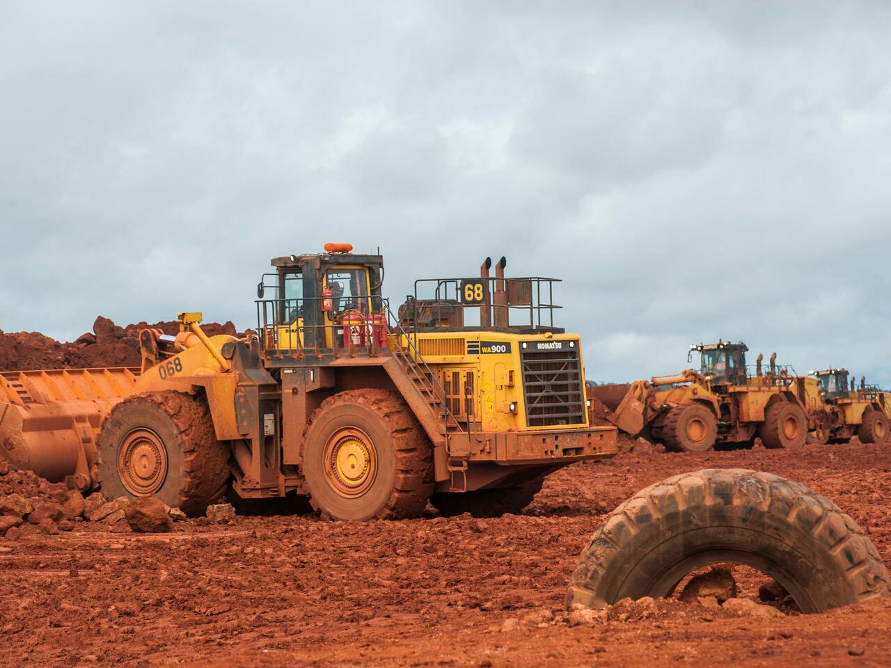 Bulldozers move raw bauxite at the Sangaredi bauxite mine operated by Compagnie des Bauxites de Guinee (CBG) near Boke, Guinea on Tuesday, Sept. 8, 2015. With 43 percent of its population of 12 million living on less than $1.25 a day, Guinea ranks amongst the most impoverished countries in the world, according to World Bank data. Photographer: Waldo Swiegers/Bloomberg via Getty Images