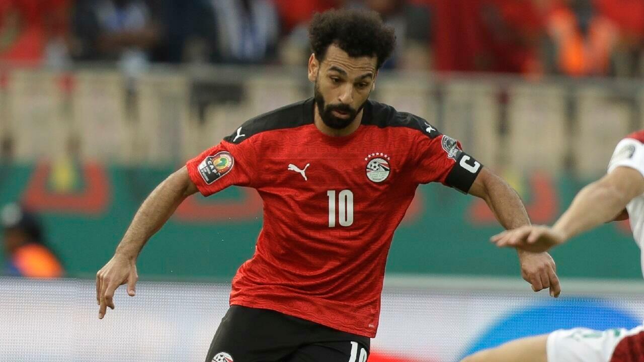 Egypt’s Mohamed Salah, left, is challenged by Morocco’s Nayef Aguerd, right, during the African Cup of Nations 2022 quarter-final soccer match between Egypt and Morocco at the Ahmadou Ahidjo stadium in Yaounde, Cameroon, Sunday, Jan. 30, 2022. (AP Photo/Sunday Alamba)