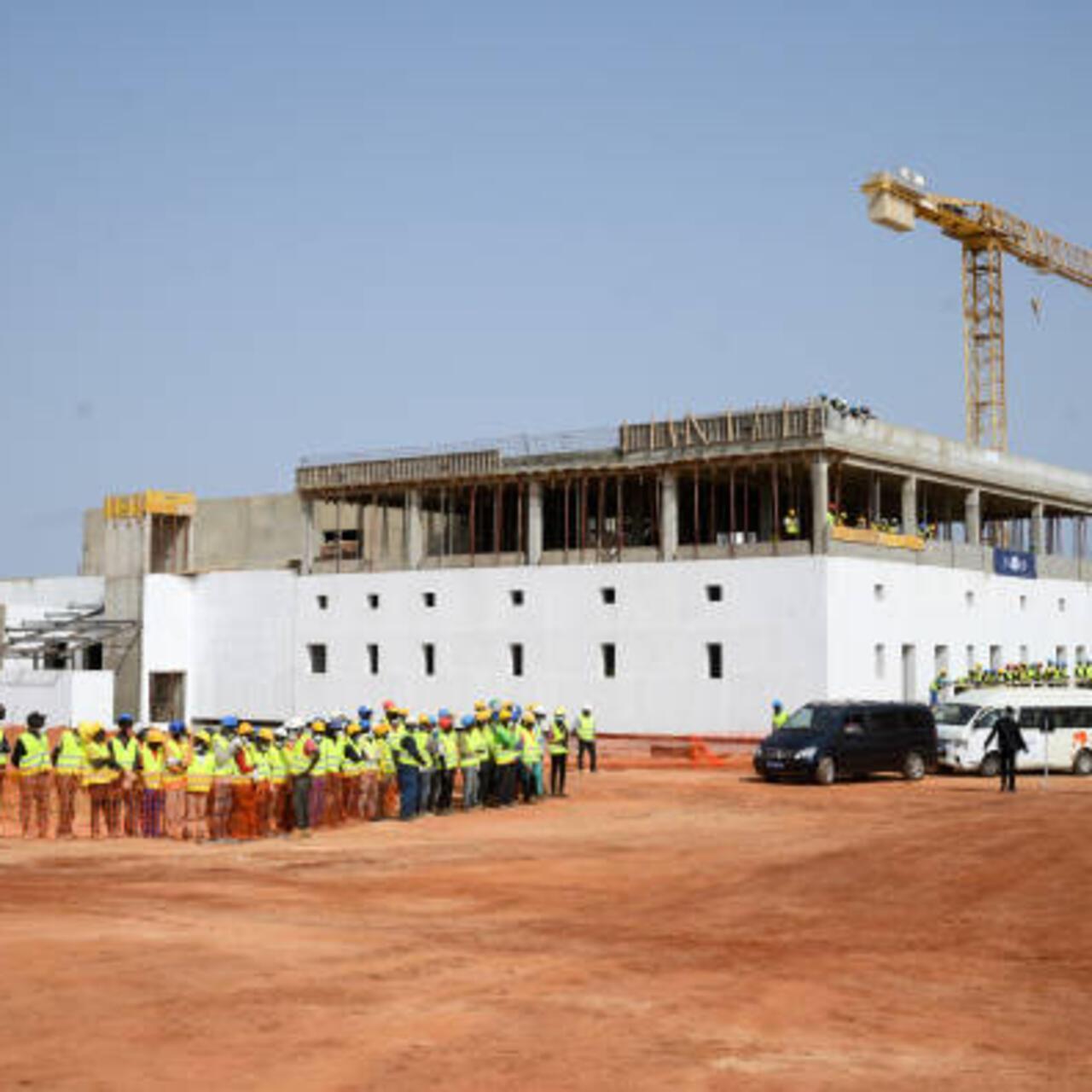22 February 2022, Senegal, Diamniadio: Construction workers stand on the site of the future vaccine production facility of Biontech and the Institut Pasteur de Dakar in Diamniadio in the Dakar region during President Steinmeier’s visit. The construction of the factory for vaccines against Covid-19 and other endemic diseases is supported by Germany and the EU, among others. President Steinmeier is on a three-day visit to the West African Republic of Senegal. Photo: Bernd von Jutrczenka/dpa (Photo by Bernd von Jutrczenka/picture alliance via Getty Images)