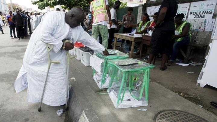 A man on crutches casts his vote at a polling unit at the start of voting in Apapa district in Lagos March 28, 2015. REUTERS/Kunle Ajayi