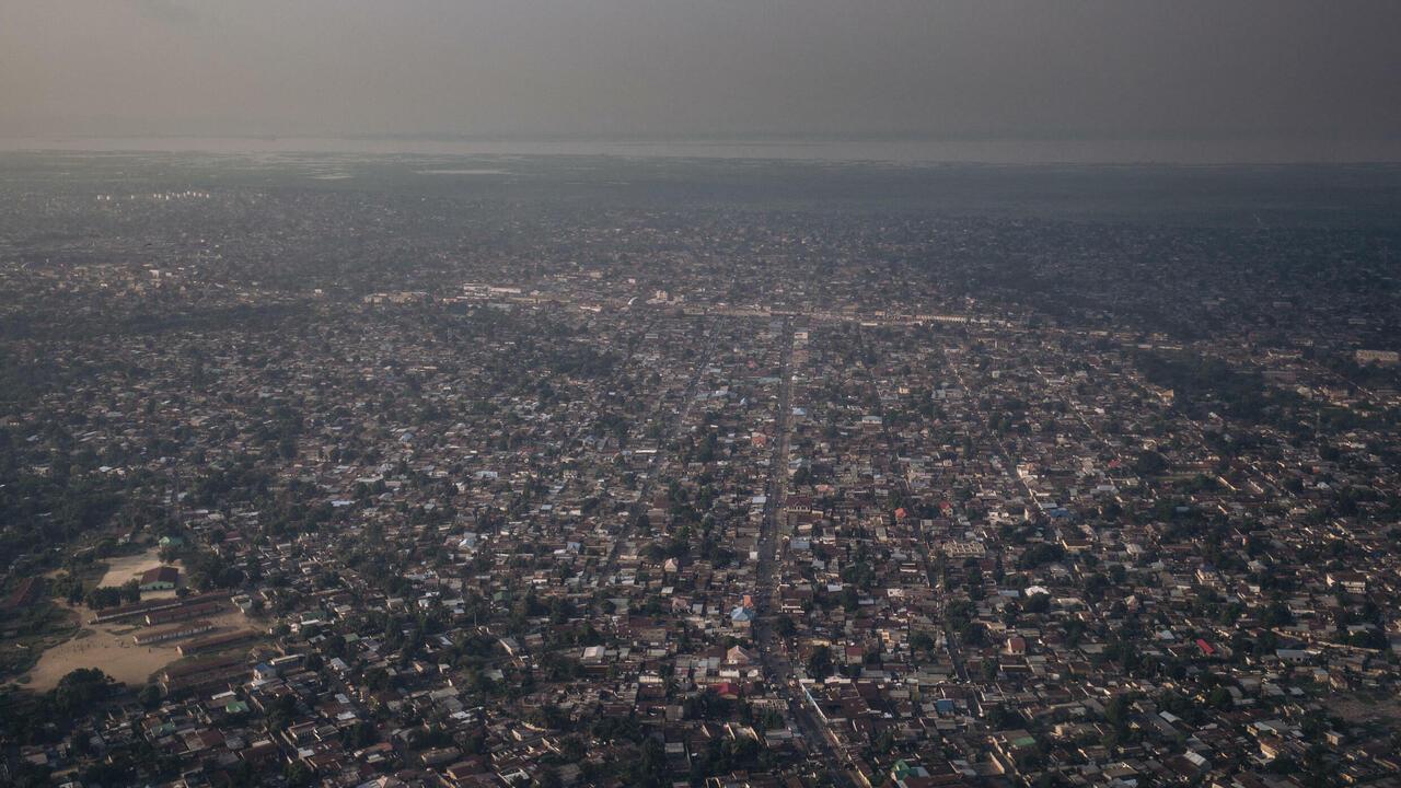 This photograph, taken on February 8, 2021 shows an aerial view of Kinshasa at sunset, capital city of the Democratic Republic of Congo. (Photo by ALEXIS HUGUET / AFP)